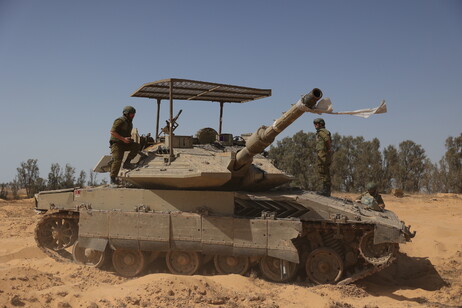 Israeli armoured vehicles gather along the border fence with southern Gaza Strip