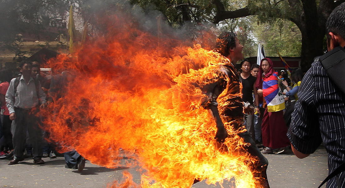 A Tibetan exile runs as he set fire to himself in New Delhi during a protest 2012 © EPA