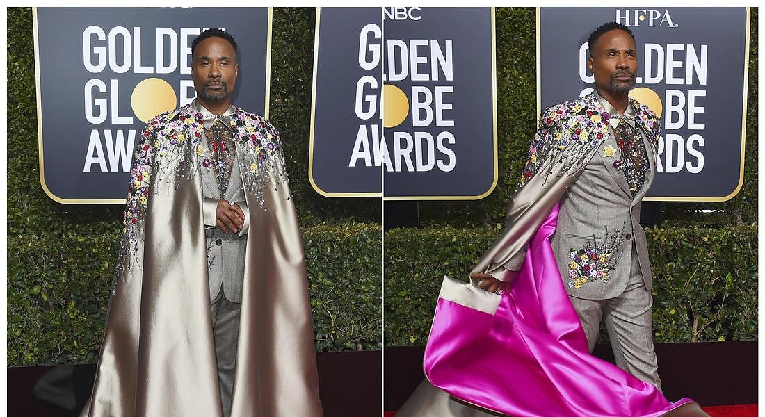 Billy Porter, look stravagante ai Golden Globe 2019 con un abito ricamato e mantello coordinato con fodera rosa. © AP