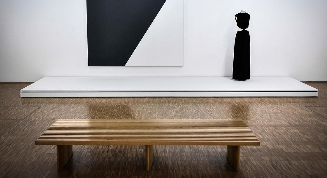 a creation of late French fashion designer  Yves Saint-Laurent displayed next a painting entitled 