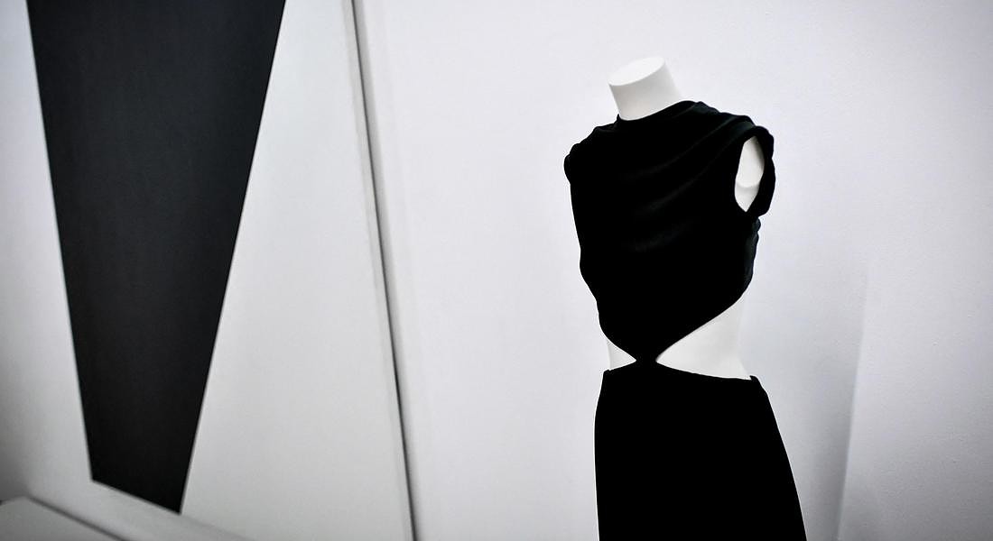 a creation of late French fashion designer  Yves Saint-Laurent displayed next a painting entitled 