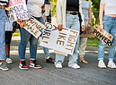 Group of young women standing with signs during a women's day march (ANSA)