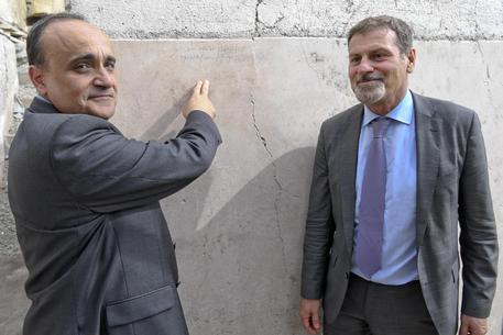 Il ministro Alberto Bonisoli con il sovrintendente Massimo Osanna mostrano la scritta su un muro  degli scavi di Pompei /FOTO CIRO FUSCO Â© ANSA