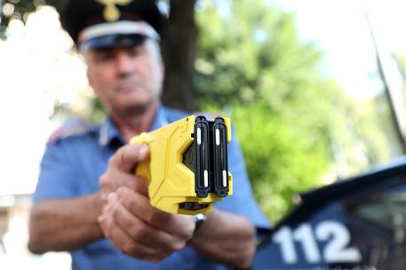Un carabiniere impugna un taser © ANSA