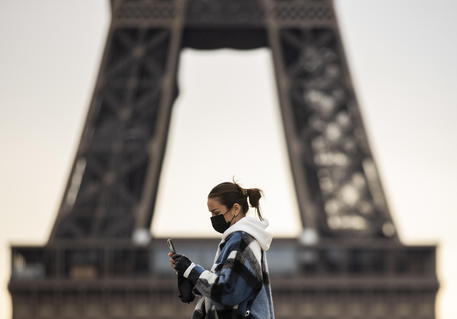 Una passante con la mascherina a Parigi © EPA