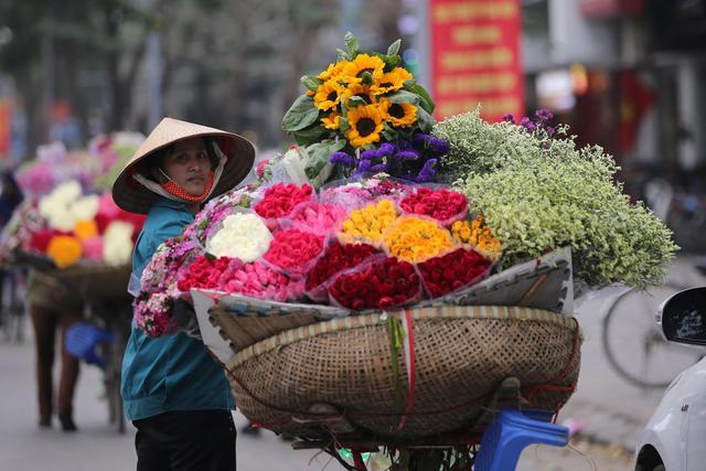 A street vendor sells flowers in Hanoi © Ansa