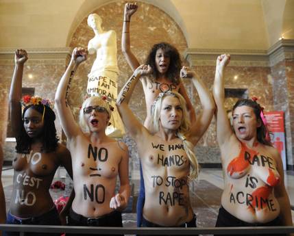 Femen activists demonstrate in the Louvre