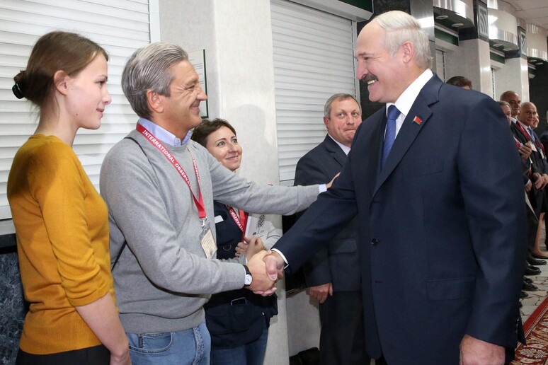 Il presidente bielorusso Alexander Lukashenko stringe le mani agli osservatori internazionali © ANSA/AP
