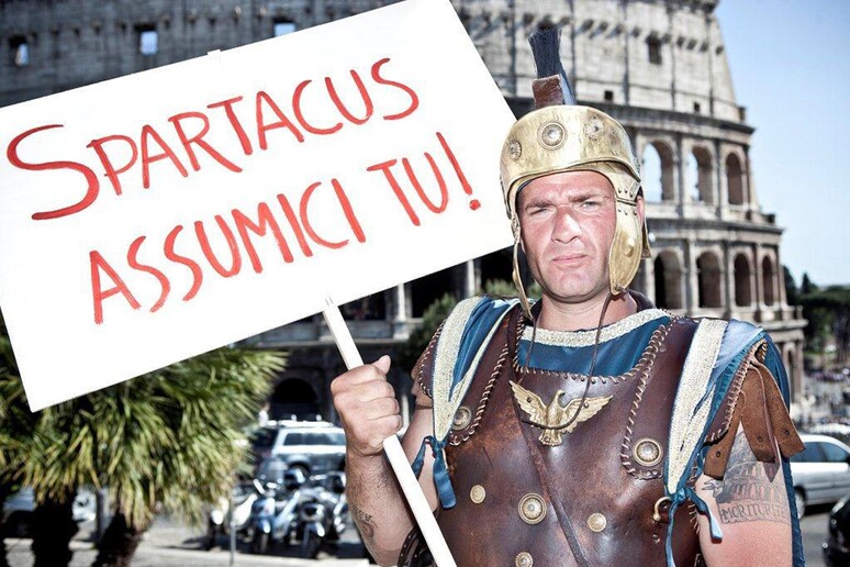 Centurion with sign saying "Hire us Spartacus" -     ALL RIGHTS RESERVED