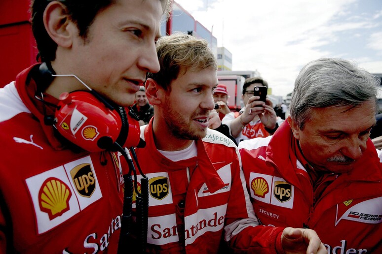 Vettel con alcuni uomini del team Ferrari © ANSA/EPA