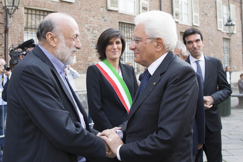 Mattarella (R) greets Slow Food founder Carlo Petrini with Turin Mayor Chiara Appendino in the background. -     ALL RIGHTS RESERVED