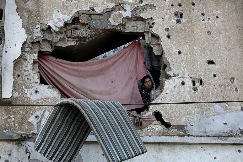 A Palestinian woman looks out from her destroyed house [ARCHIVE MATERIAL 20161013 ] - RIPRODUZIONE RISERVATA