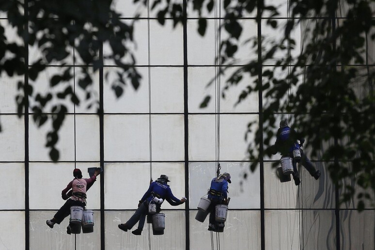 workers climb © ANSA/EPA