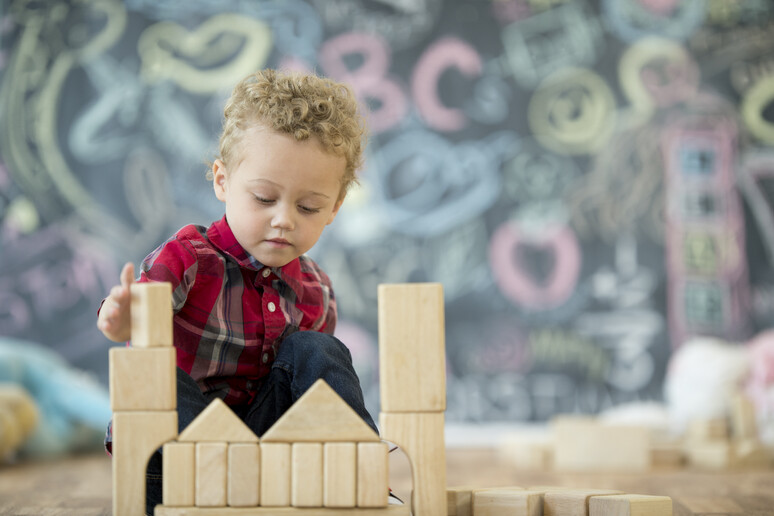 un bambino gioca con le costruzioni foto FatCamera iStock. - RIPRODUZIONE RISERVATA