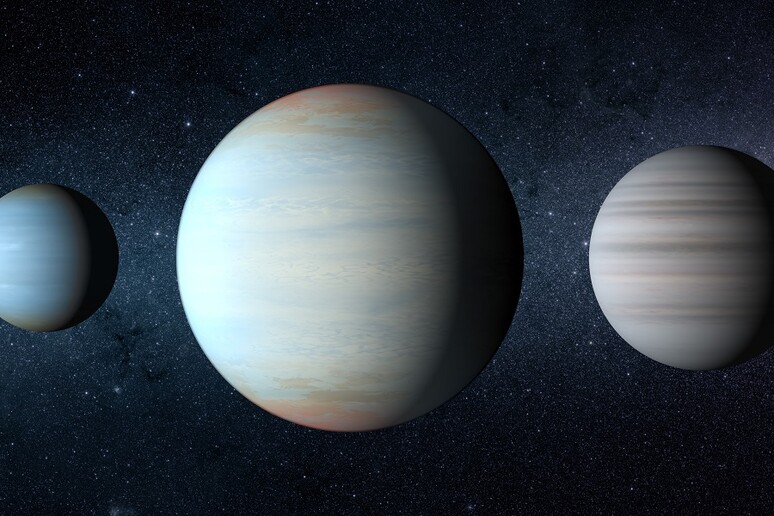 Rappresentazione artistica dei tre pianeti che ruotano intorno alla coppia di stelle Kepler-47 (fonte: NASA/JPLCaltech/T. Pyle) - RIPRODUZIONE RISERVATA