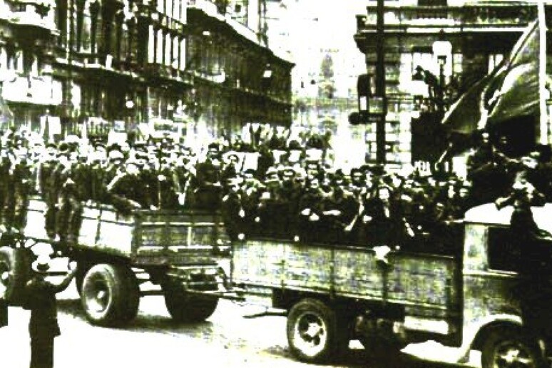 Partigiani sfilano su automezzi per le strade di Bologna dopo la liberazione /WIKIPEDIA