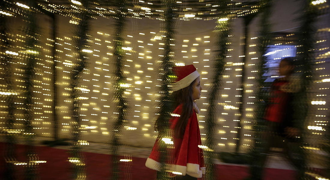 Palestinians attend the ceremony of lighting a Christmas tree in Gaza City © EPA