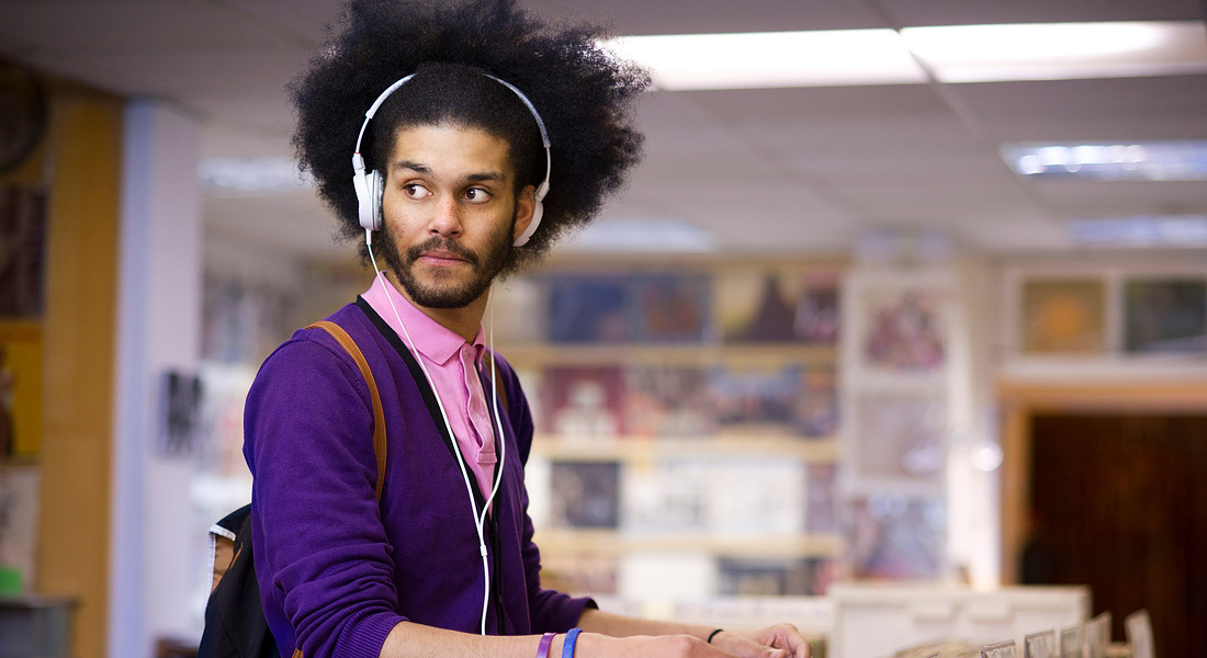 Un giovane in un negozio di dischi ascolta musica vinile foto iStock. © Ansa