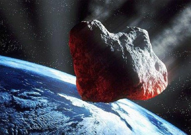 Rappresentazione artistica di un asteroide durante il passaggio ravvicinato alla Terra (fonte. ESA) © Ansa