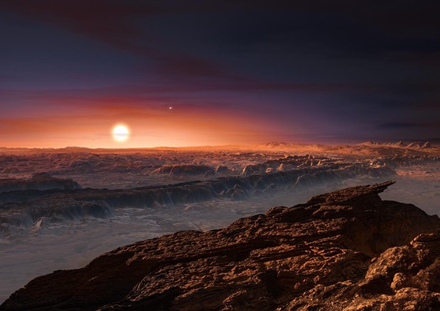 Rappresentazione artistica del pianeta Proxima Centauri b che  si trova in un sistema con tre stelle (fonte: ESO / M. Kornmesser) © Ansa
