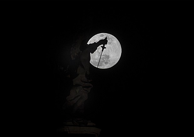 La luna visibile dietro la statua dell'arcangelo di Castel Sant'Angelo durante l'equinozio di  primavera. ANSA/Massimo Percossi © ANSA