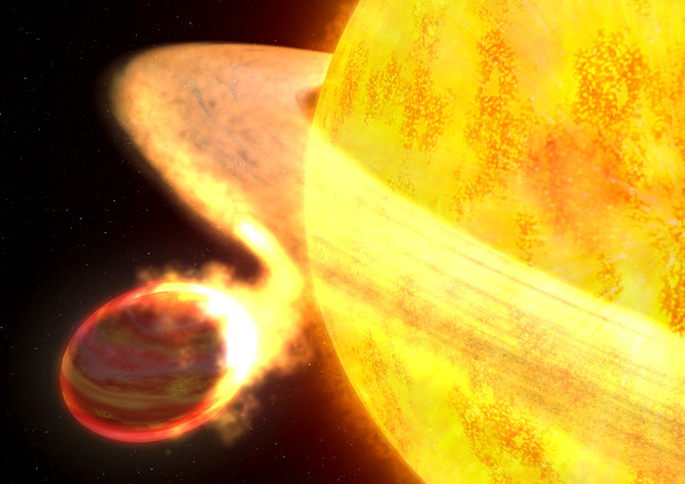 Rappresentazione artistica di una stella che divora uno dei suoi pianeti (fonte: NASA/ESA/G. BACON) © Ansa
