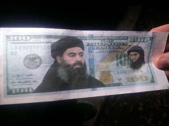 A fake 100-dollar bill with the image of Islamic State (ISIS) leader Abu Bakr al-Baghdadi