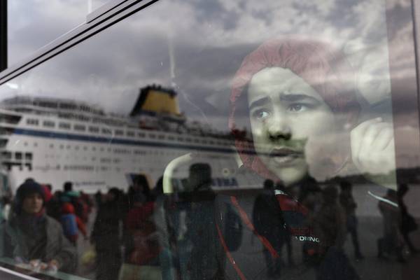 Refugees and migrants arrive at the port of Piraeus, near Athens