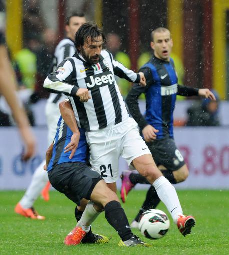 Il giocatore della Juventus Andrea Pirlo contrastato da un avversario , Sabato 30 Marzo 2013, allo stadio Giuseppe Meazza di Milano durante la partita di Campionato Serie A Inter Juventus © ANSA 