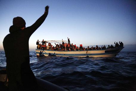 Profughi a bordo di un barcone a largo della Libia © ANSA