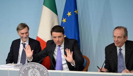 Il premier Matteo Renzi (C), con il ministro dell'Economia Pier Carlo Padoan (D) e il sottosegretario alla presidenza del consiglio Graziano Delrio FOTO ARCHIVIO © ANSA 