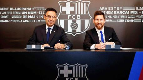 Lionel Messi firma il nuovo contratto col presidente del Barcellona Josep Maria Bartomeu © EPA