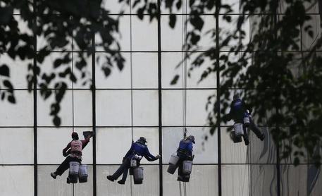 workers climb © EPA