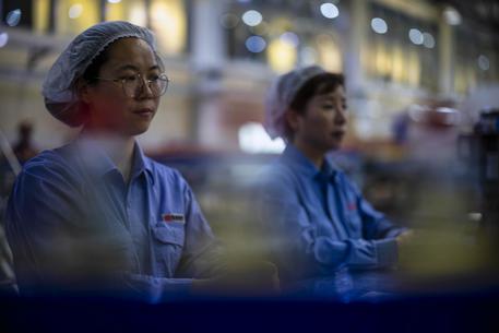Lavoratori in un'industria cinese © EPA
