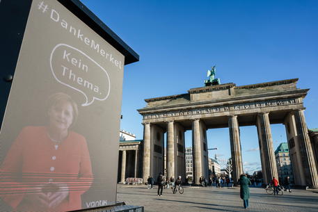 Advertisement showing Merkel on display in Berlin © EPA