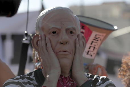 Un manifestante con la maschera di Benjamin Netanyahu © EPA