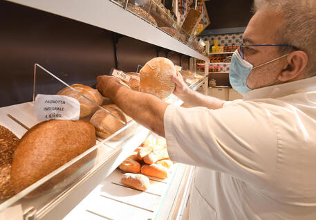 Un panettiere al lavoro nel suo negozio, Milano © ANSA
