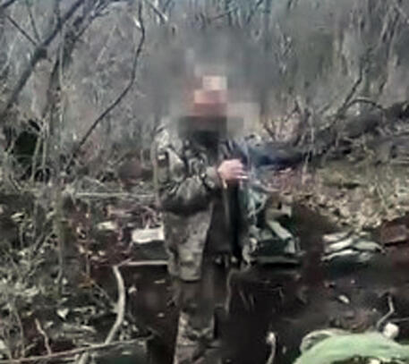 Un'immagine del video shock, con il volto coperto © ANSA