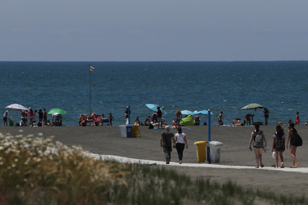 People relax and enjoy a sunny day in Ostia