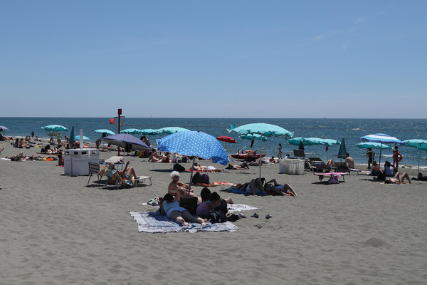 People relax and enjoy a sunny day in Ostia