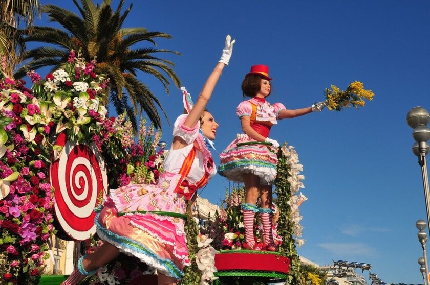 Una ragazza in costume lancia un mazzo di mimose alla sfilata di carnevale di Nizza - ALL RIGHTS RESERVED
