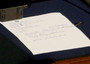 Un foglio scritto dal presidente del Consiglio Silvio Berlusconi dopo il voto nell'Aula della Camera, l'8 novembre del 2011. Il Cav lascia Palazzo Chigi, al suo posto arrivera' Monti