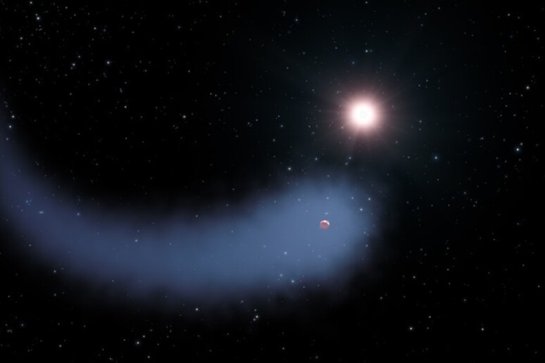 Rappresentazione artistica del ‘pianeta con la coda’ GJ436b, in orbita intorno a una nana rossa a circa 30 anni luce dalla Terra (fonte ESA/Hubble). - RIPRODUZIONE RISERVATA