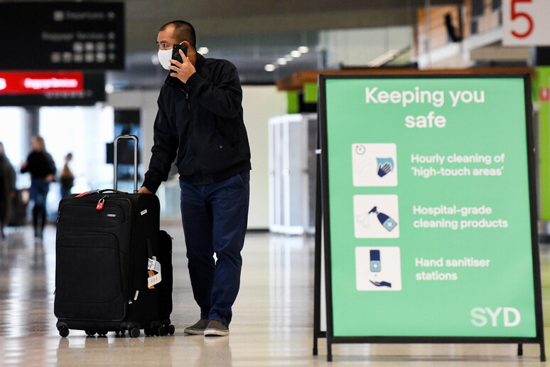Un passeggero indossa una mascherina nell 'aeroporto di Melbourne. Immagine d 'archivio © ANSA/EPA