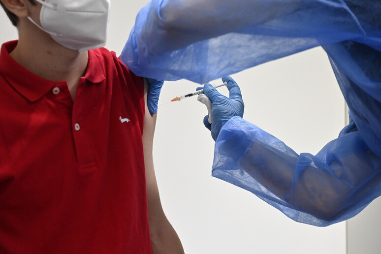 un giovane riceve una vaccinazione in una foto d 'archivio - RIPRODUZIONE RISERVATA