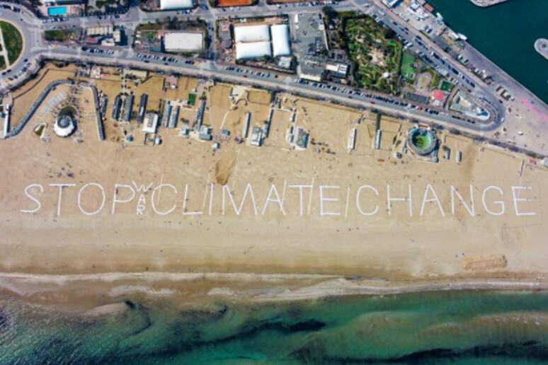 Mega scritta in spiaggia a Rimini,  'stop climate change ' - RIPRODUZIONE RISERVATA