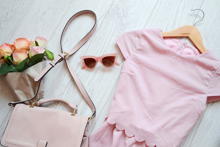Fashionable concept, pink style. Dress, bag and glasses. View from above  iStock. - RIPRODUZIONE RISERVATA