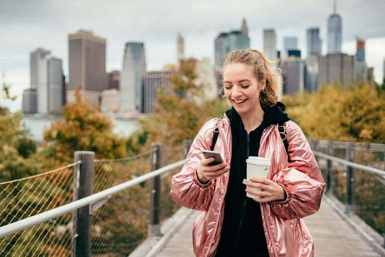 New York , una giovane donna con smartphone foto iStock. -     RIPRODUZIONE RISERVATA